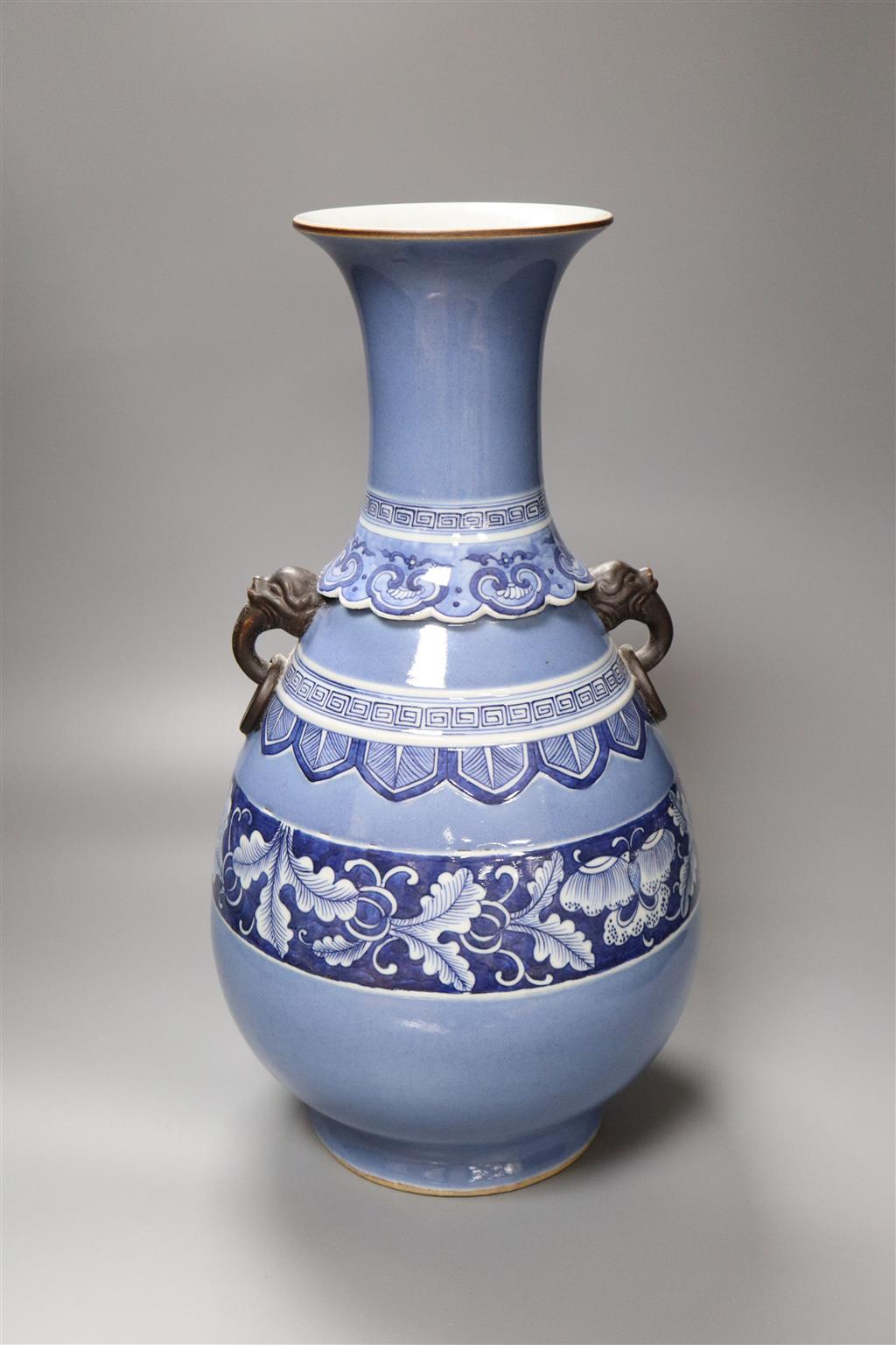 A large Chinese bulbous blue vase, with mask and ring handles, 45cm